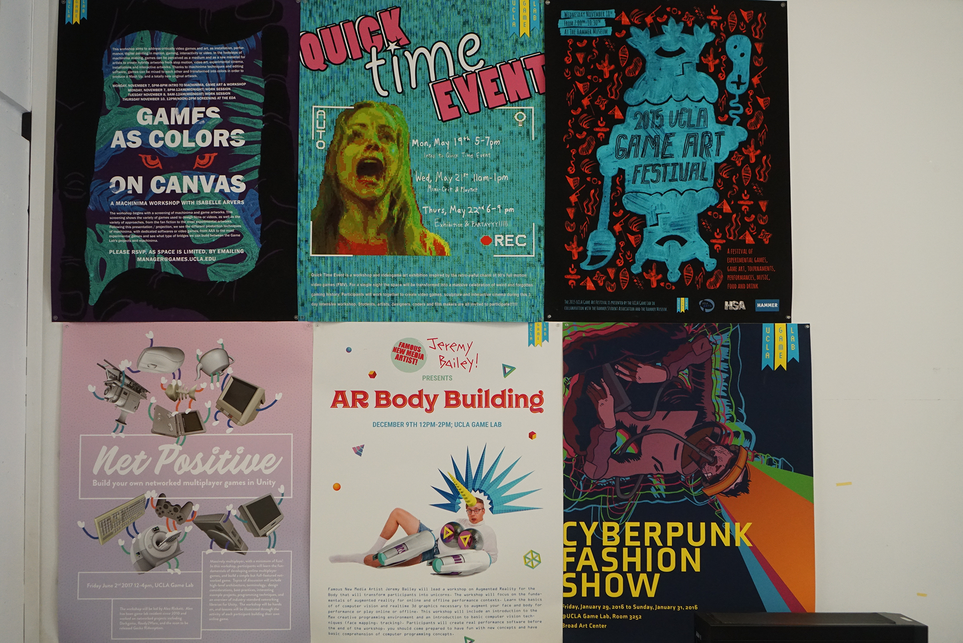 A close-up view of a white wall adorned with six vibrant, uniquely designed posters advertising different game-related events, workshops, and festivals.